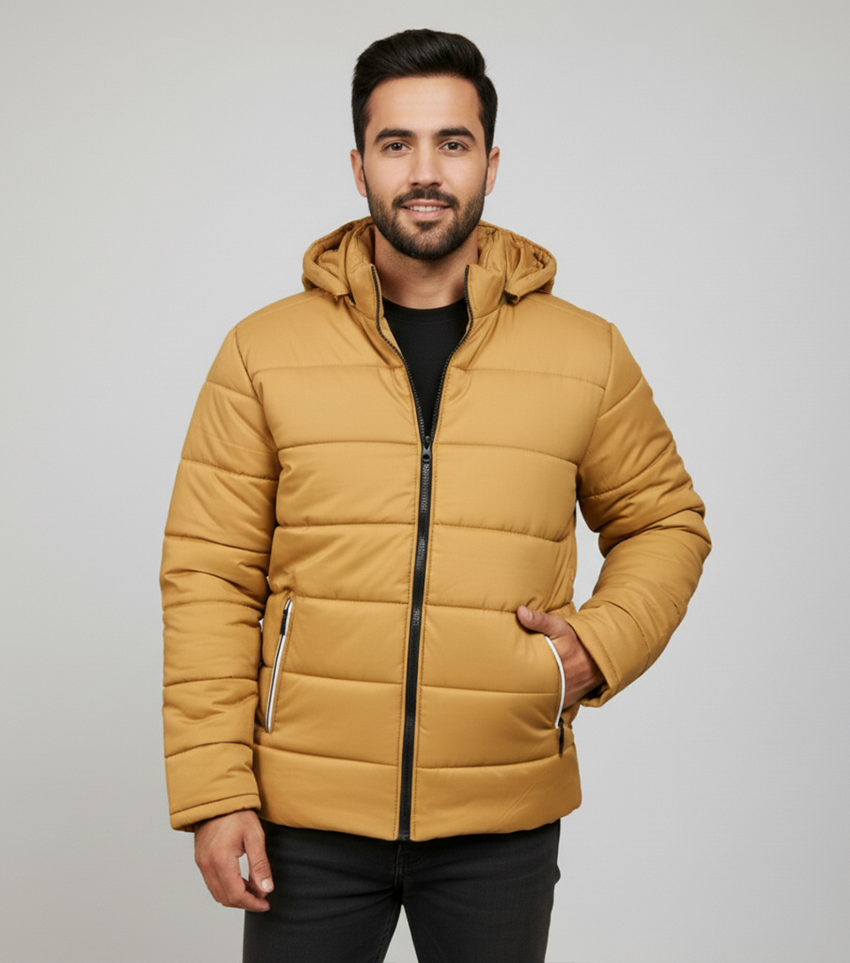 Distinct mustard color with bold, earthy appeal Classic horizontal puffer quilting for premium insulation Attached hood for added wind and rain protection Black contrast zipper with white-trimmed pull details Contemporary fit with a clean, modern silhouette Secure functional zipper pockets with unique pull tabs